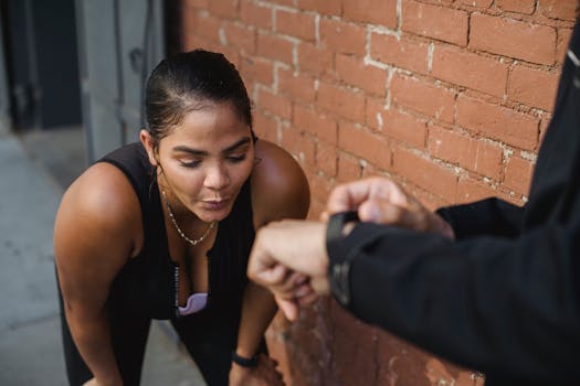 Woman in sportswear catching breath after intense exercise outdoors.