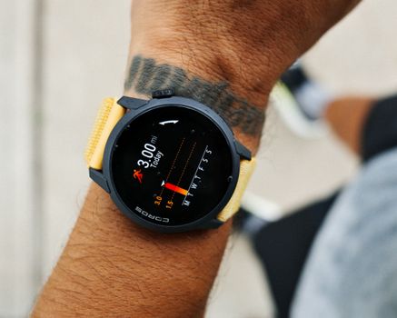 Close-up view of a smartwatch tracking a 3-mile run, worn by a male runner in Houston, TX.